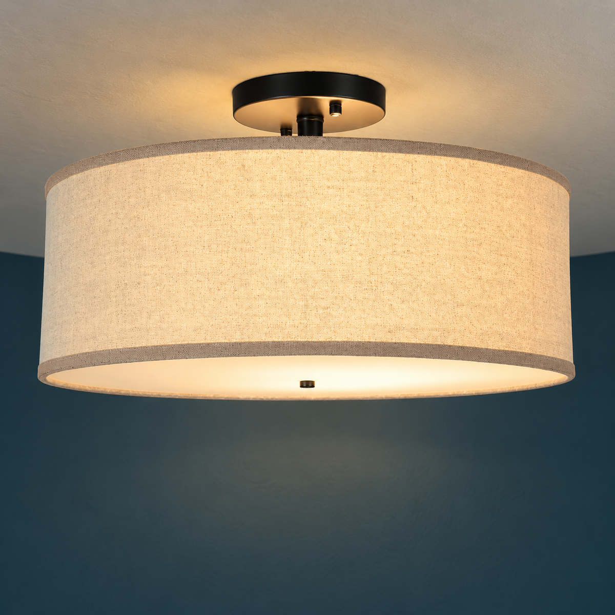 Close-up of the oatmeal linen drum and black ceiling plate of the Naline light