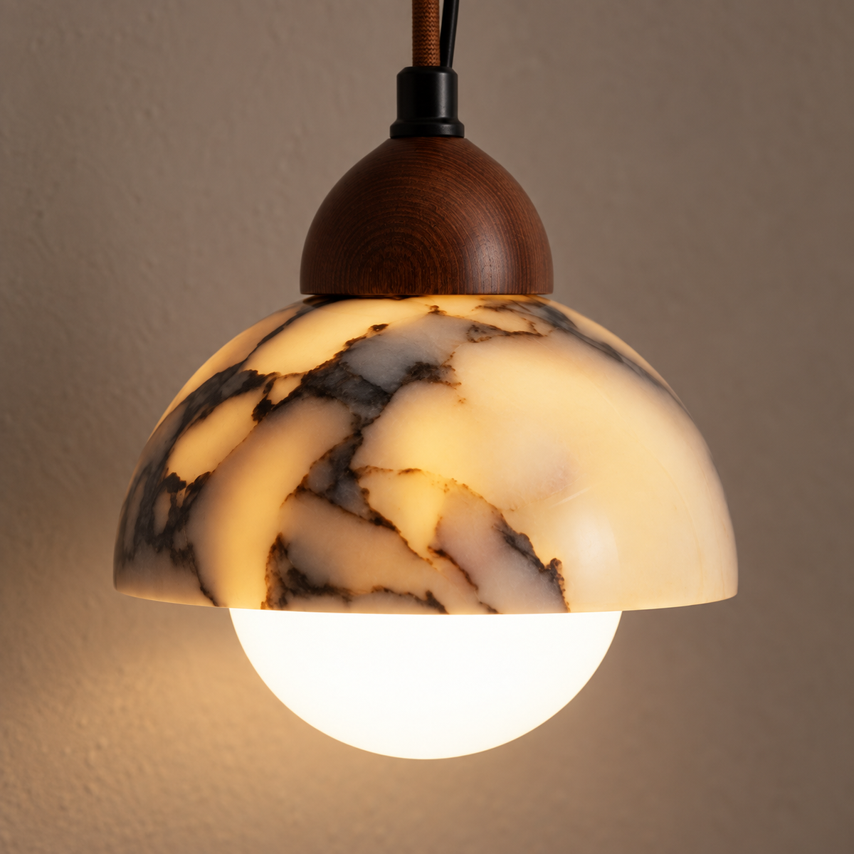 Close-up of the marbled ceramic dome and opal globe of the Valina pendant light